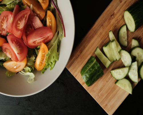 Fresh colorful vegetable salad on a wooden table indicating healthy nutrition
